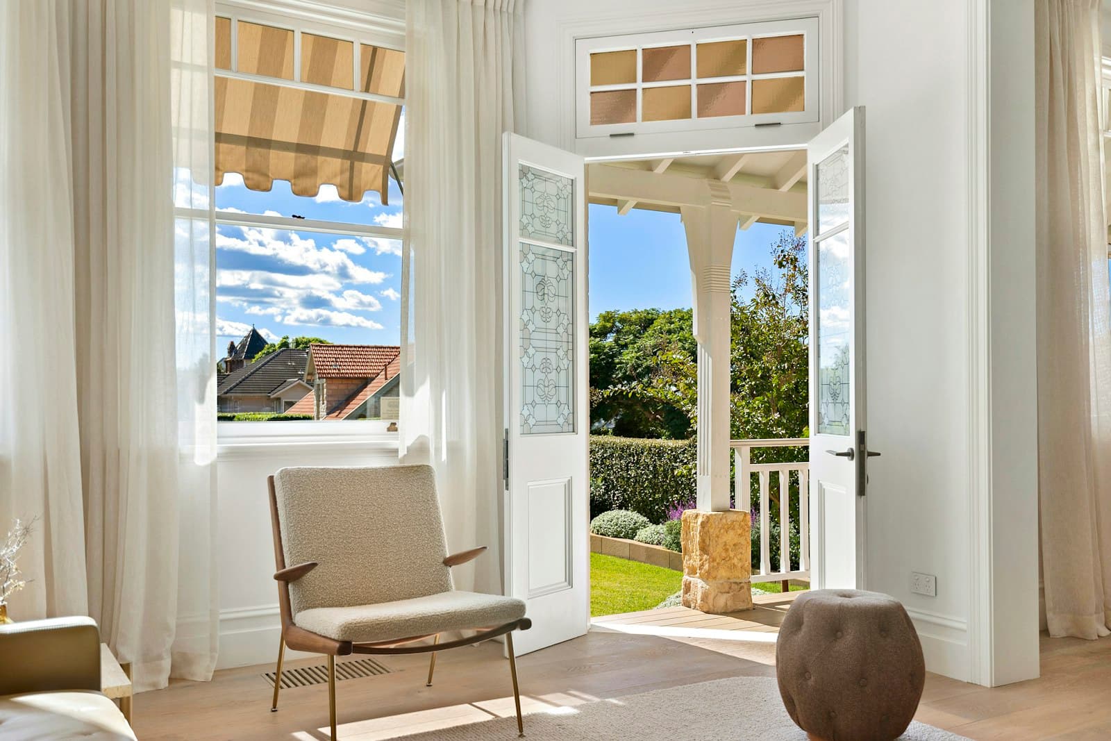 French doors opening from a bright room to a backyard