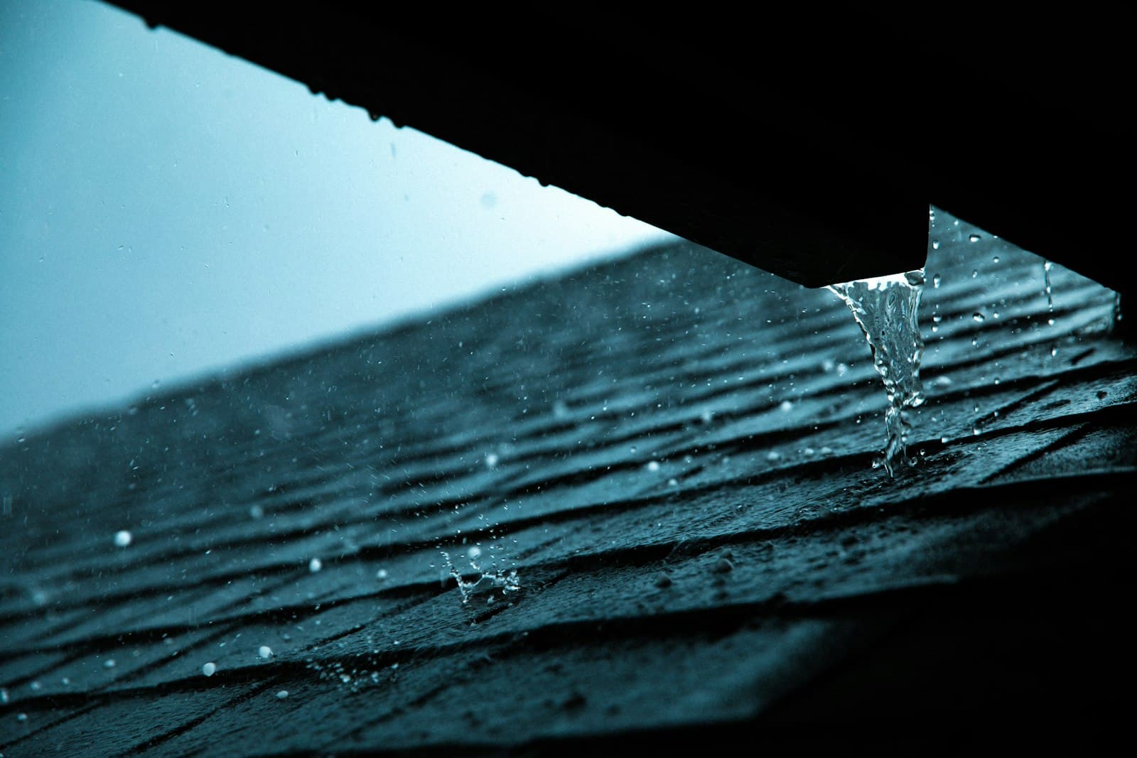 Close-up of a roof edge and gutter after a storm