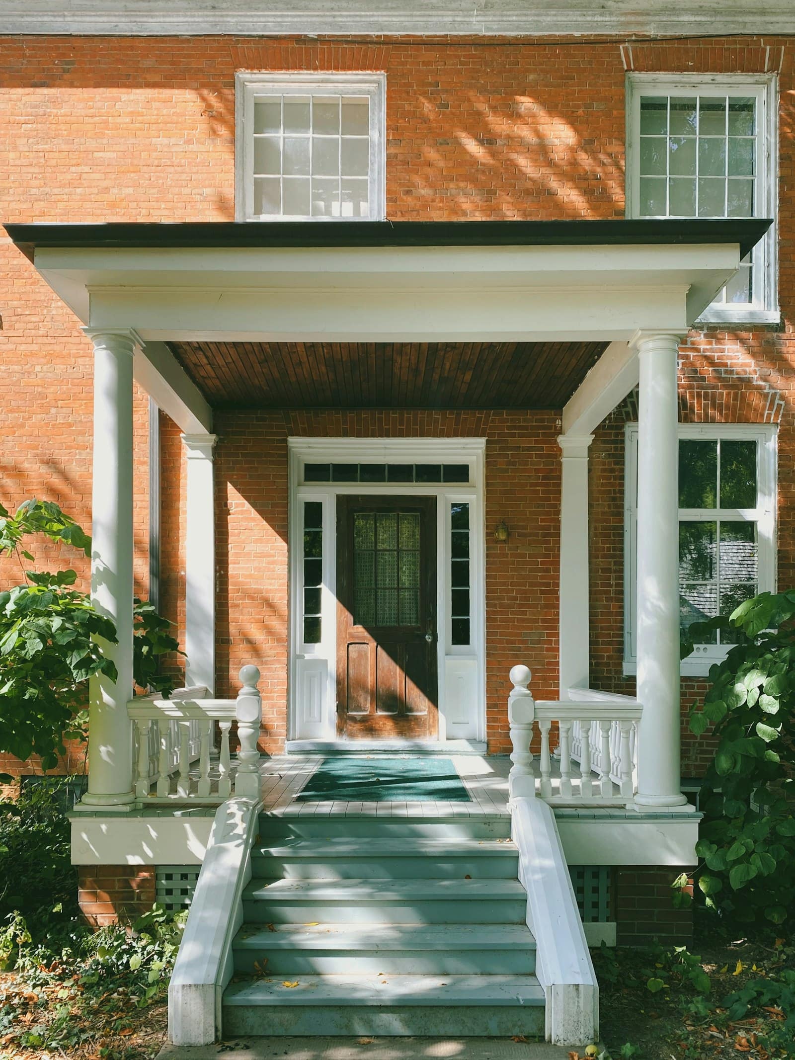 Brick house with a white front door and strong curb appeal