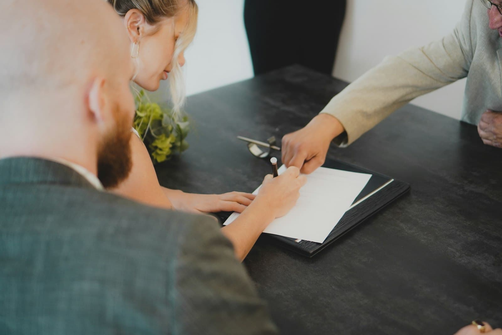 Signing warranty documents at a desk